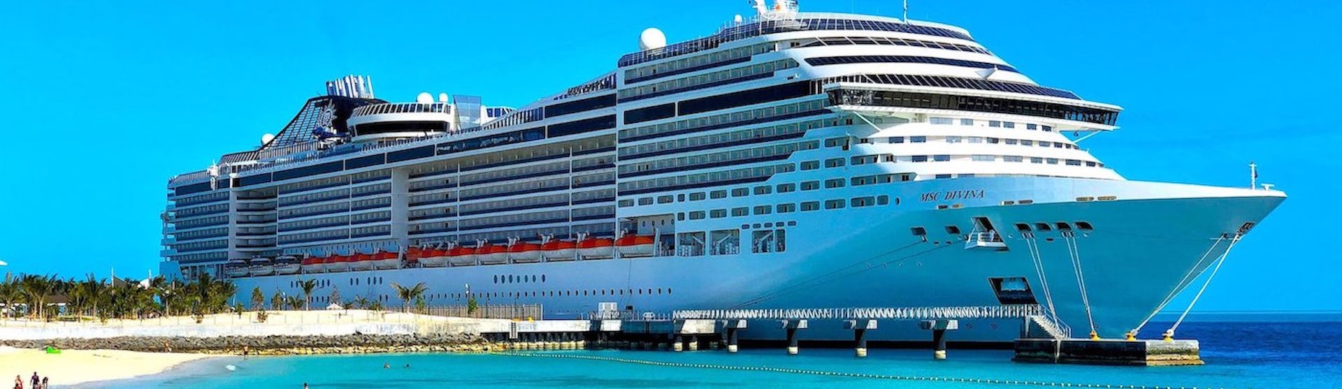 MSC Divina ship on clear blue water beach