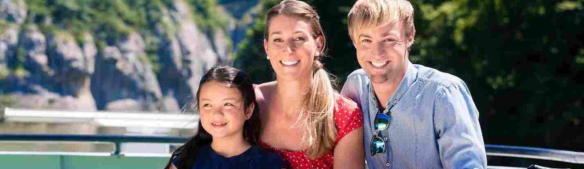 Family smiling on a river cruise