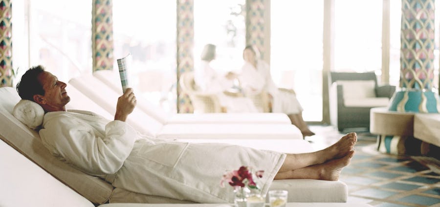 person relaxing in a spa reading a magazine